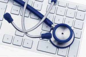 stethoscope on top of a keyboard, representing IT computer services for medical practices